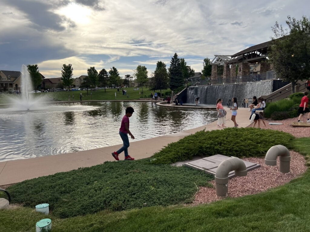 Families enjoying the outdoor pond and parks of Wolf Ranch