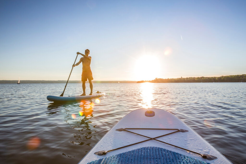 stand up paddleboarder on the water