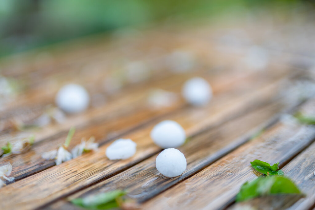 hail pebbles on a wooden deck outside
