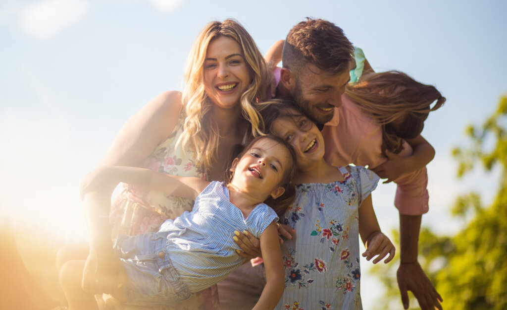 Happy family. Parents with daughters in nature.