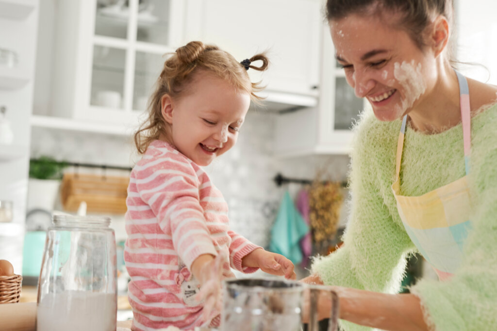 Mum and her little daughter enjoying in the kitchen