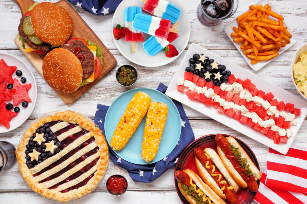 Patriotic, American themed food. Above view table scene on a white wood background.