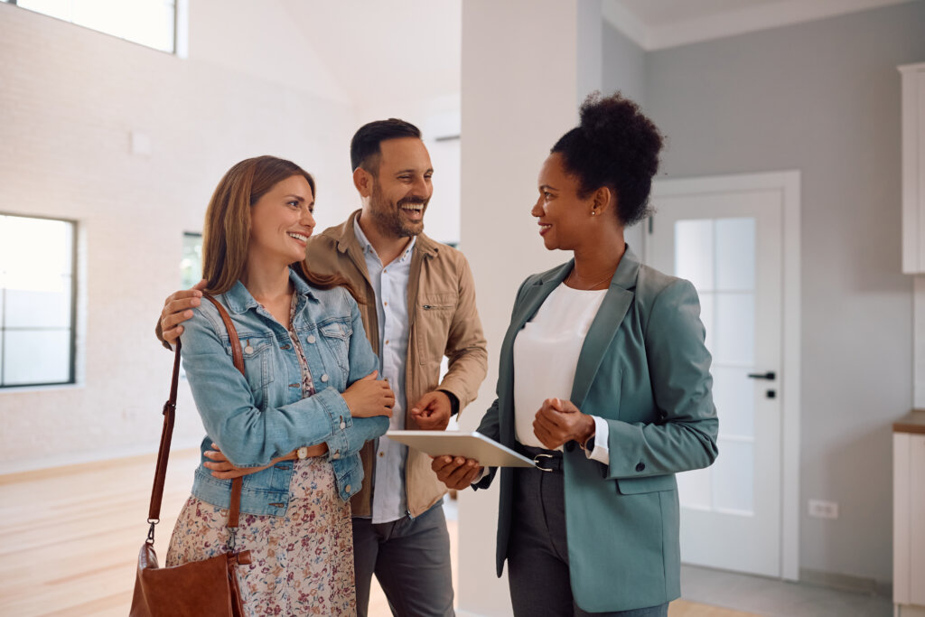 sales associate walking a couple through their new house