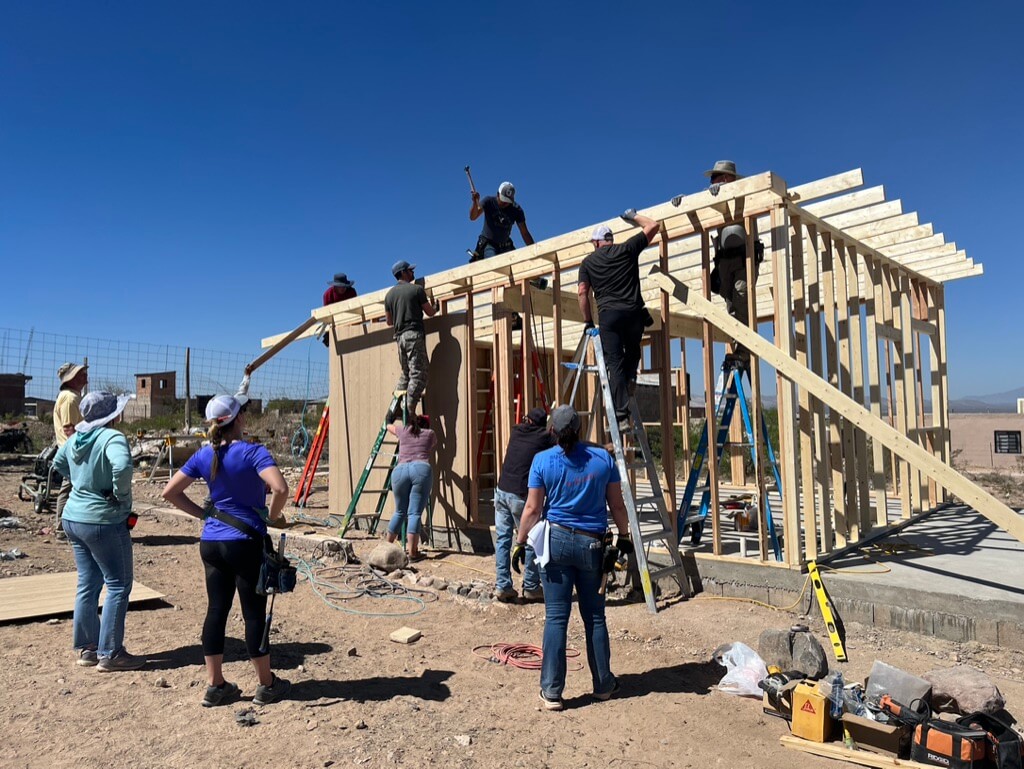 challenger homes employees working together to build a home for charity