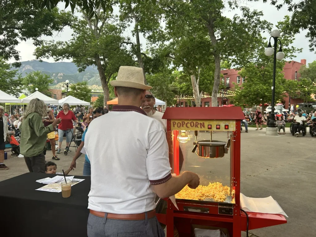 Man selling popcorn at an outdoor festival