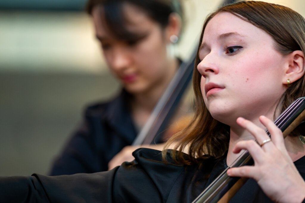 Young orchestral musician playing music