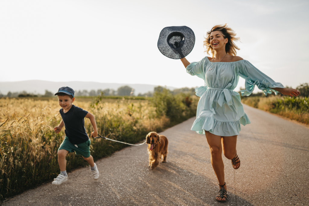 Mother and son enjoying time outside with their dog